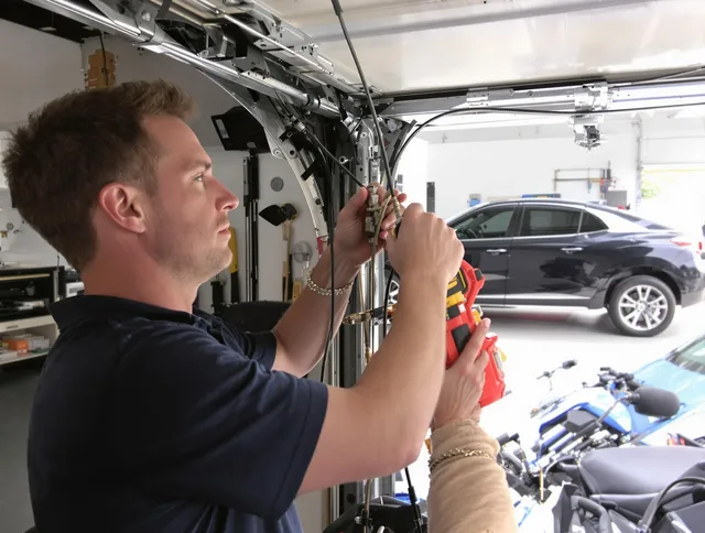 Lakeland Garage Door Repair safety certified technician performing cable replacement in Lakeland